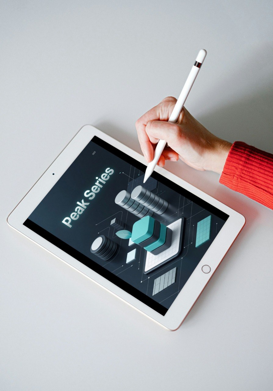 Person using a stylus on a tablet with 'Peak Series' displayed